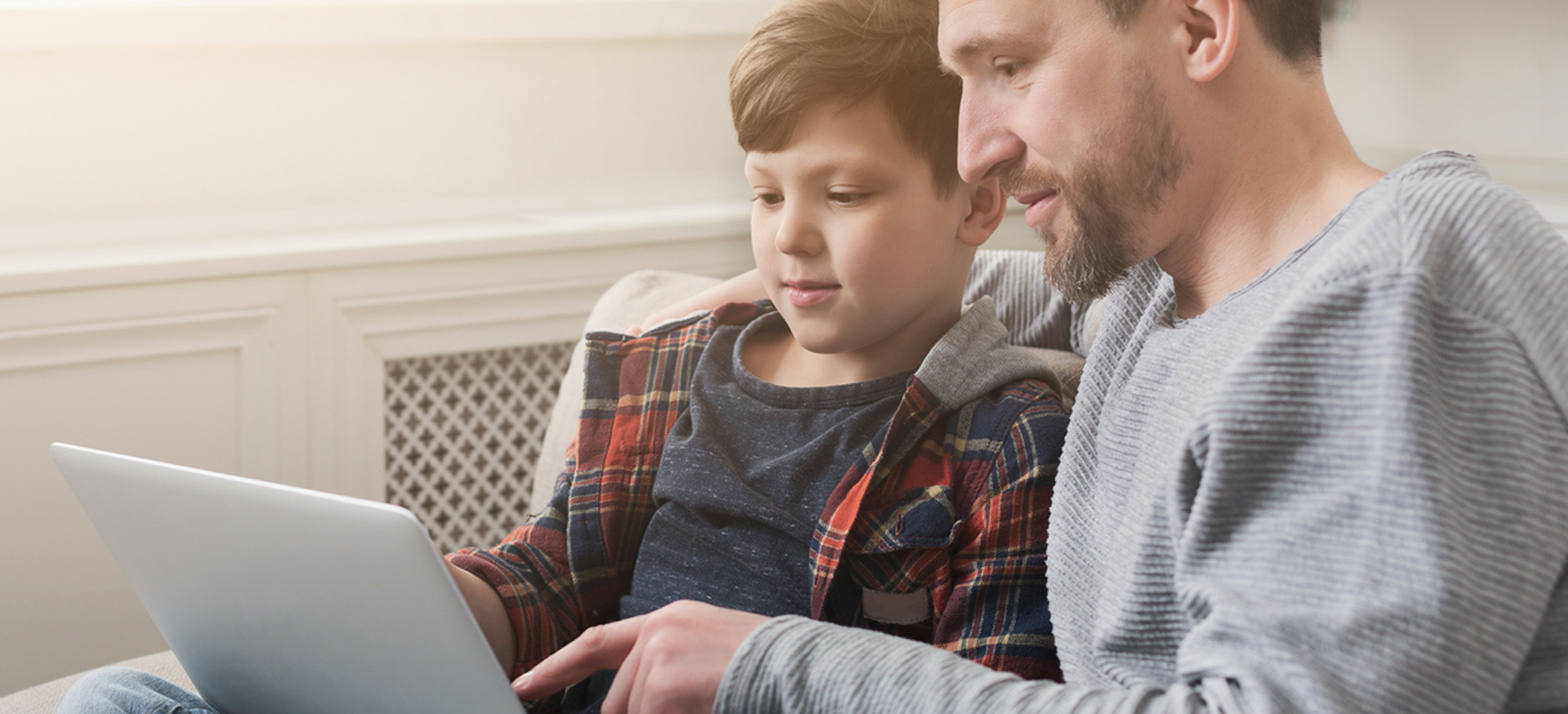 Father and son explore a device