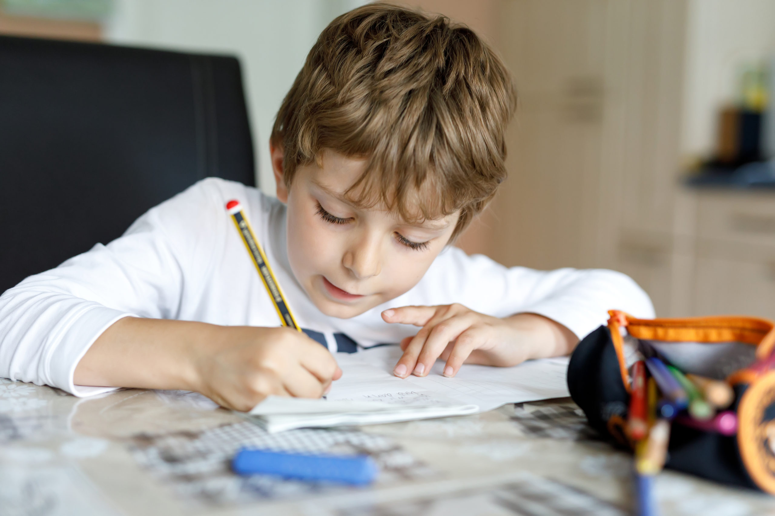 Boy doing schoolwork at table