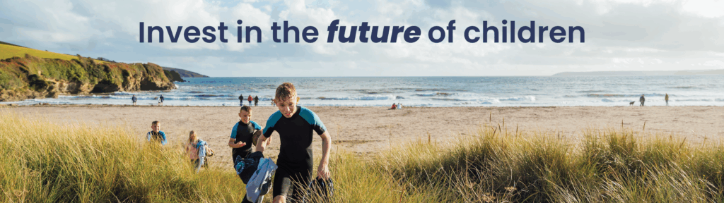Boys running through sand dunes