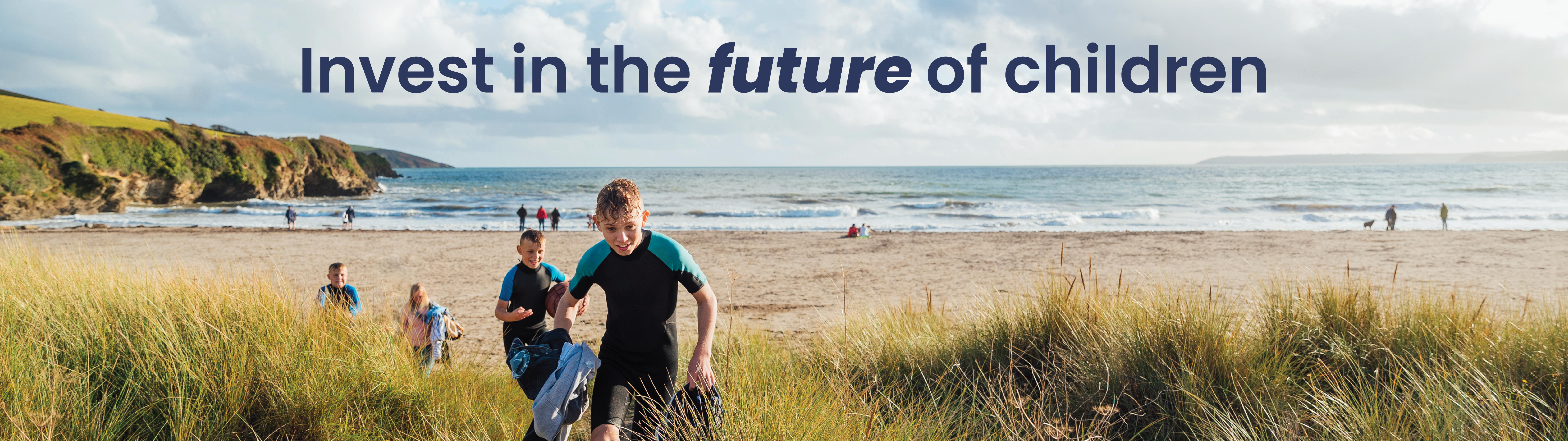 Boys running through sand dunes